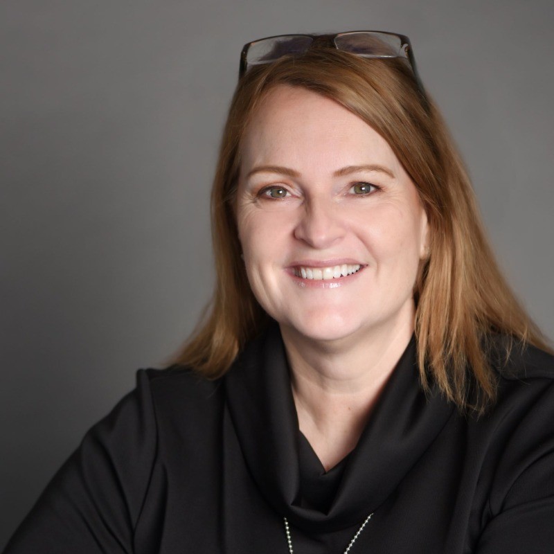 A person standing in front of a signDescription automatically generated